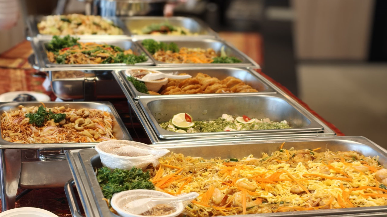 Thai buffet dishes arranged in catering trays